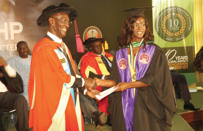 Rev. Dr Kwabena 	Darko, Chancellor of the Regent University College, presenting a gift to Chinonye Ogochwuku Eke